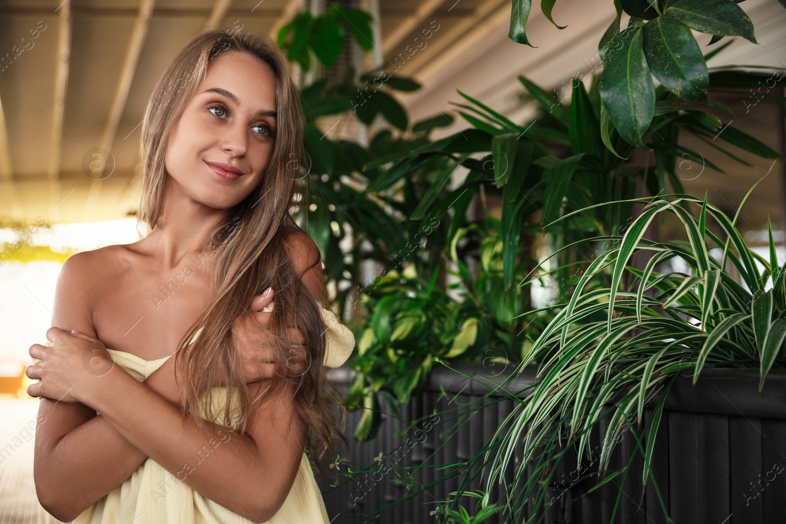 Photo of Beautiful young woman sitting on indoor terrace