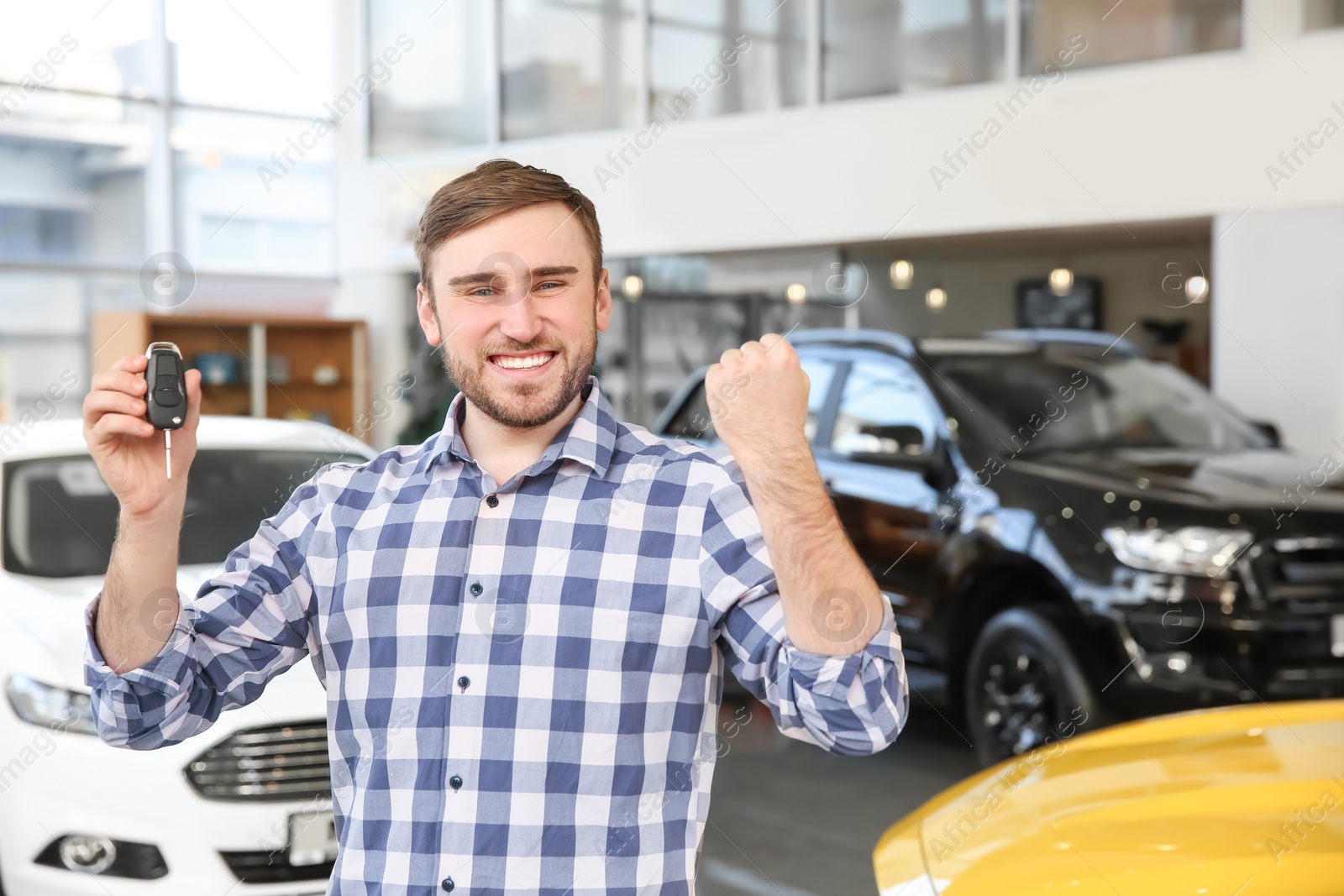 Photo of Young man holding car key in salon