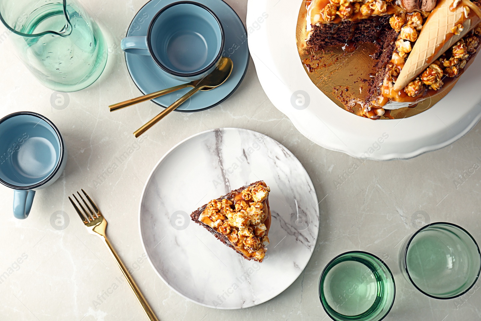 Photo of Delicious homemade cake with caramel sauce and tableware on light background, top view