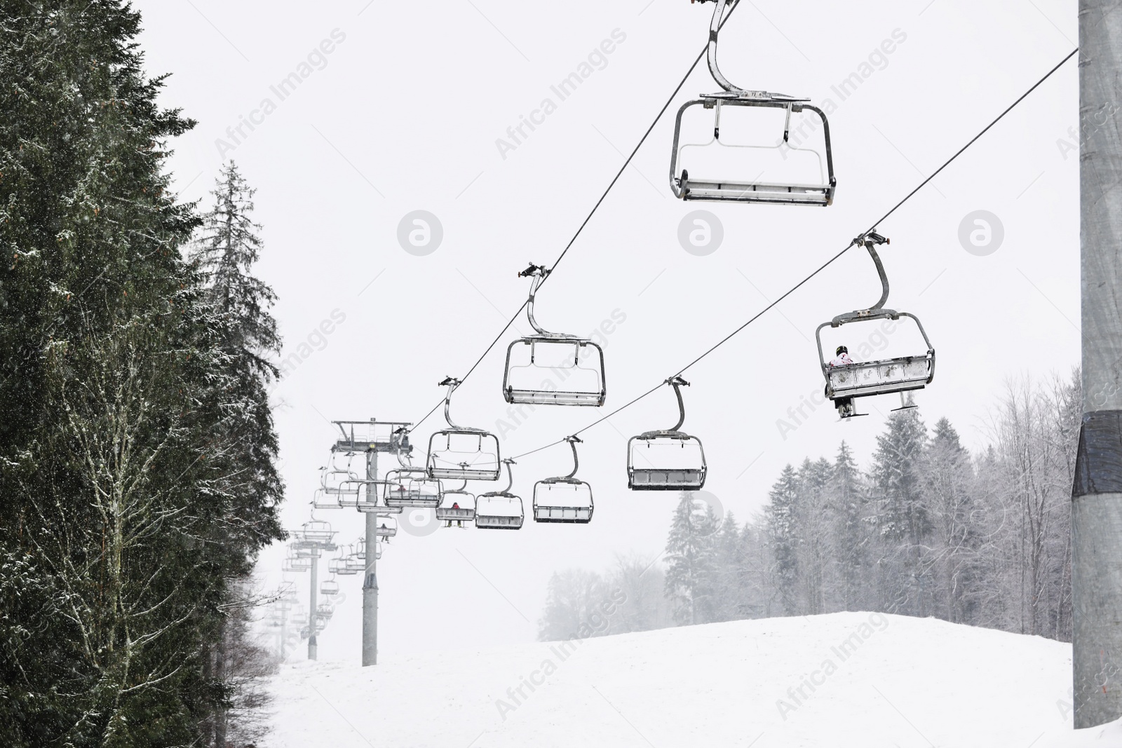 Photo of Ski lift at mountain resort. Winter vacation