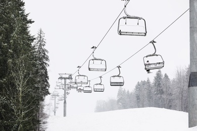 Photo of Ski lift at mountain resort. Winter vacation