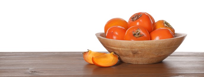 Photo of Delicious ripe juicy persimmons with bowl on wooden table against white background