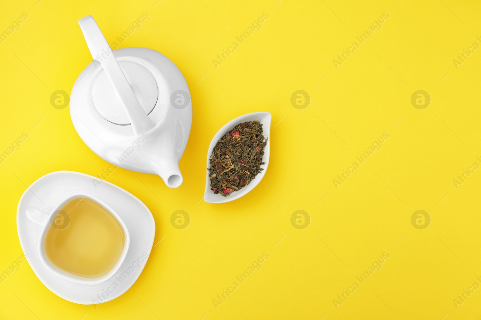 Photo of Composition with tea on yellow background, flat lay. Space for text