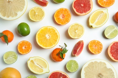 Different citrus fruits on white background, flat lay