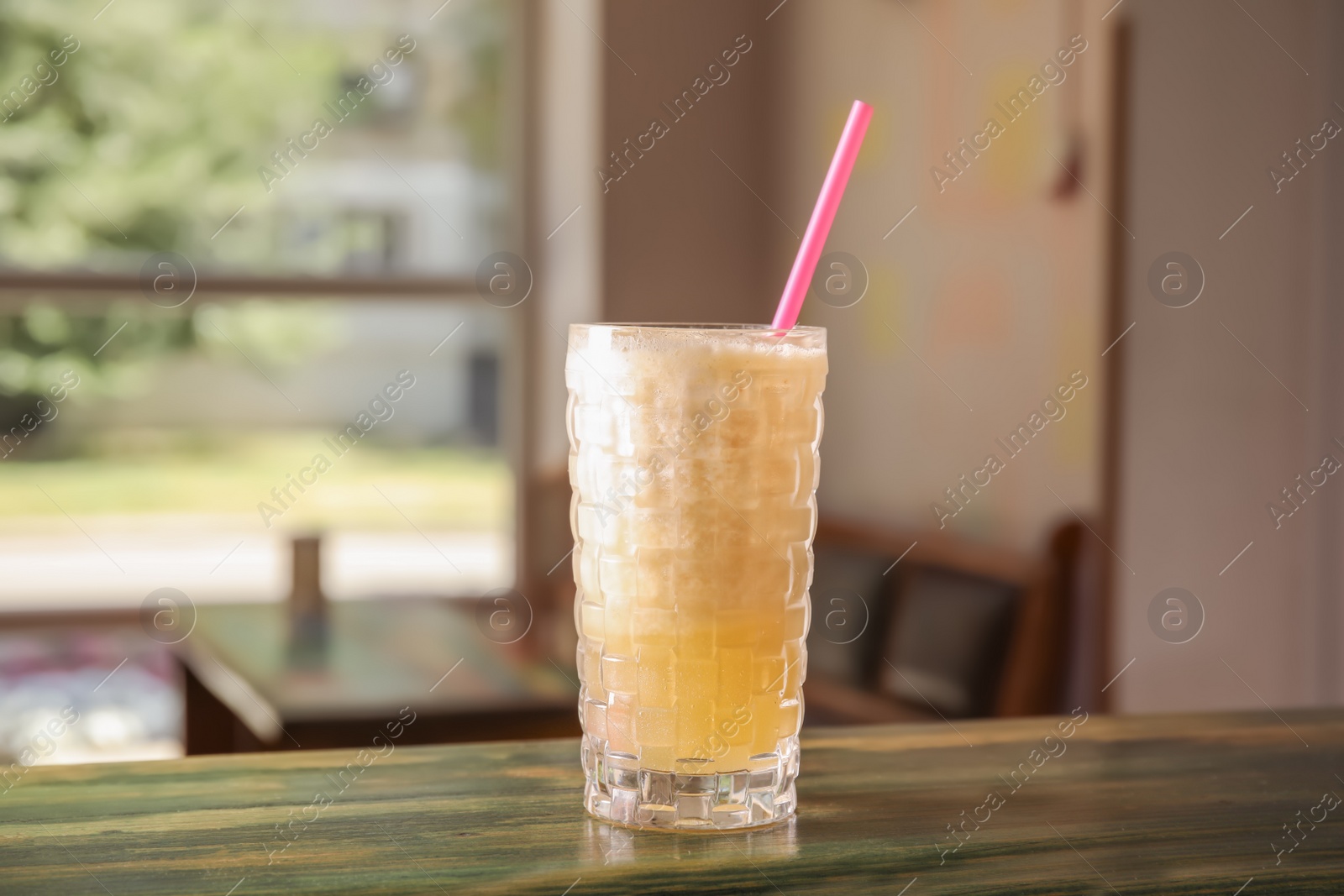 Photo of Glass with delicious cocktail on counter in cafe