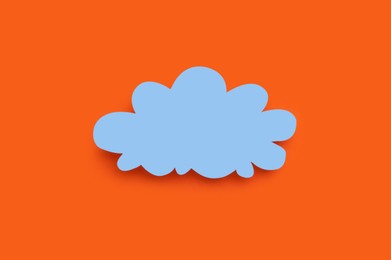 Photo of Paper speech bubble in shape of cloud on orange background, top view. Space for text
