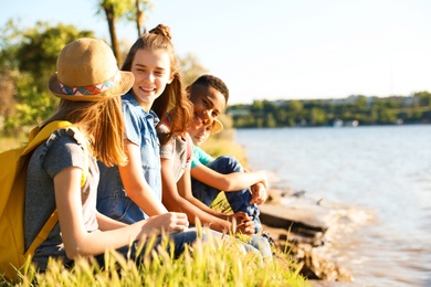 Photo of Group of children with backpacks on coast. Summer camp