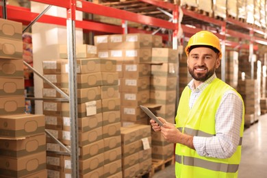 Man with tablet working at warehouse. Logistics center