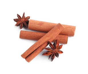 Photo of Aromatic cinnamon sticks and anise stars isolated on white, top view