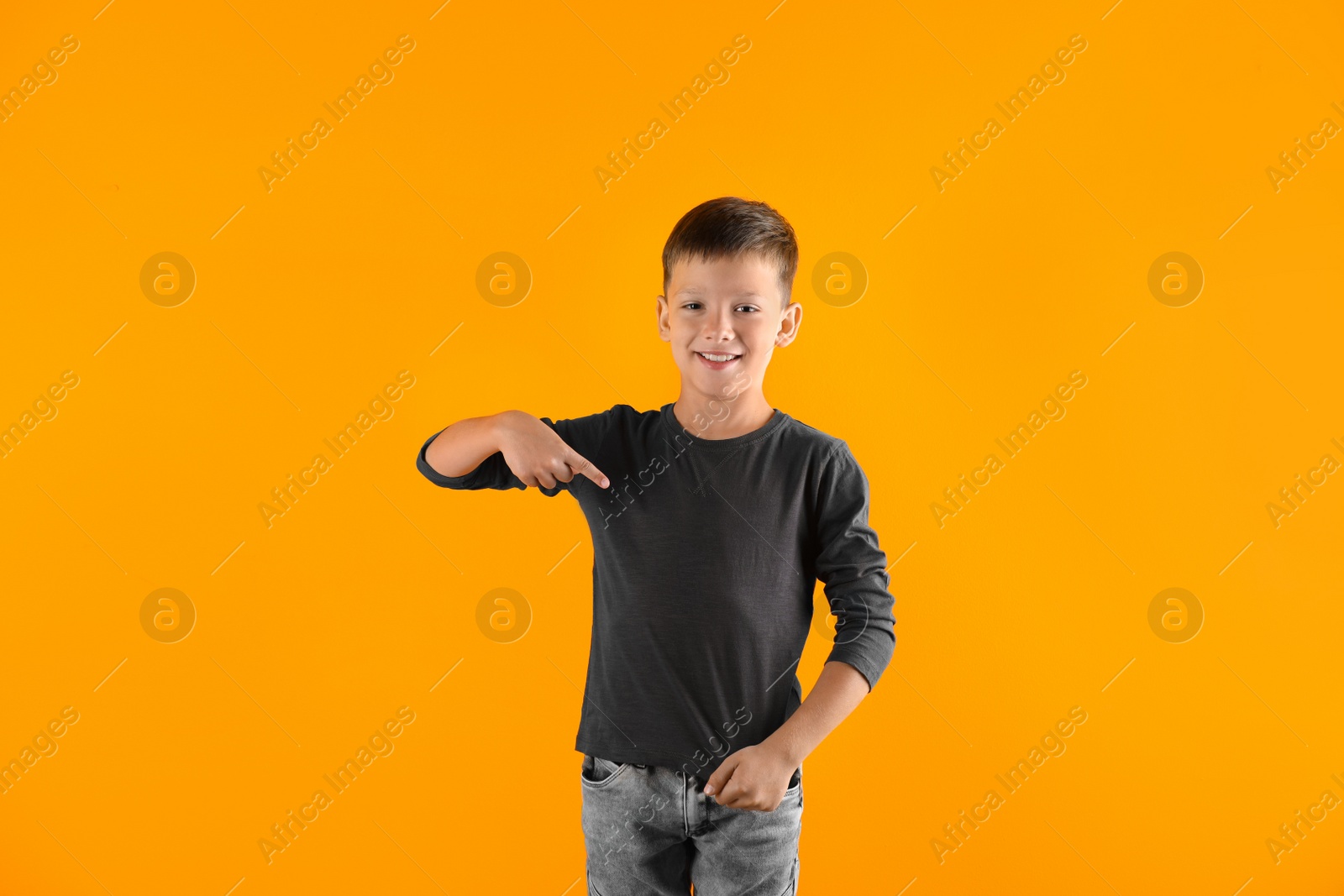 Photo of Little boy in long sleeve t-shirt on color background. Mock-up for design