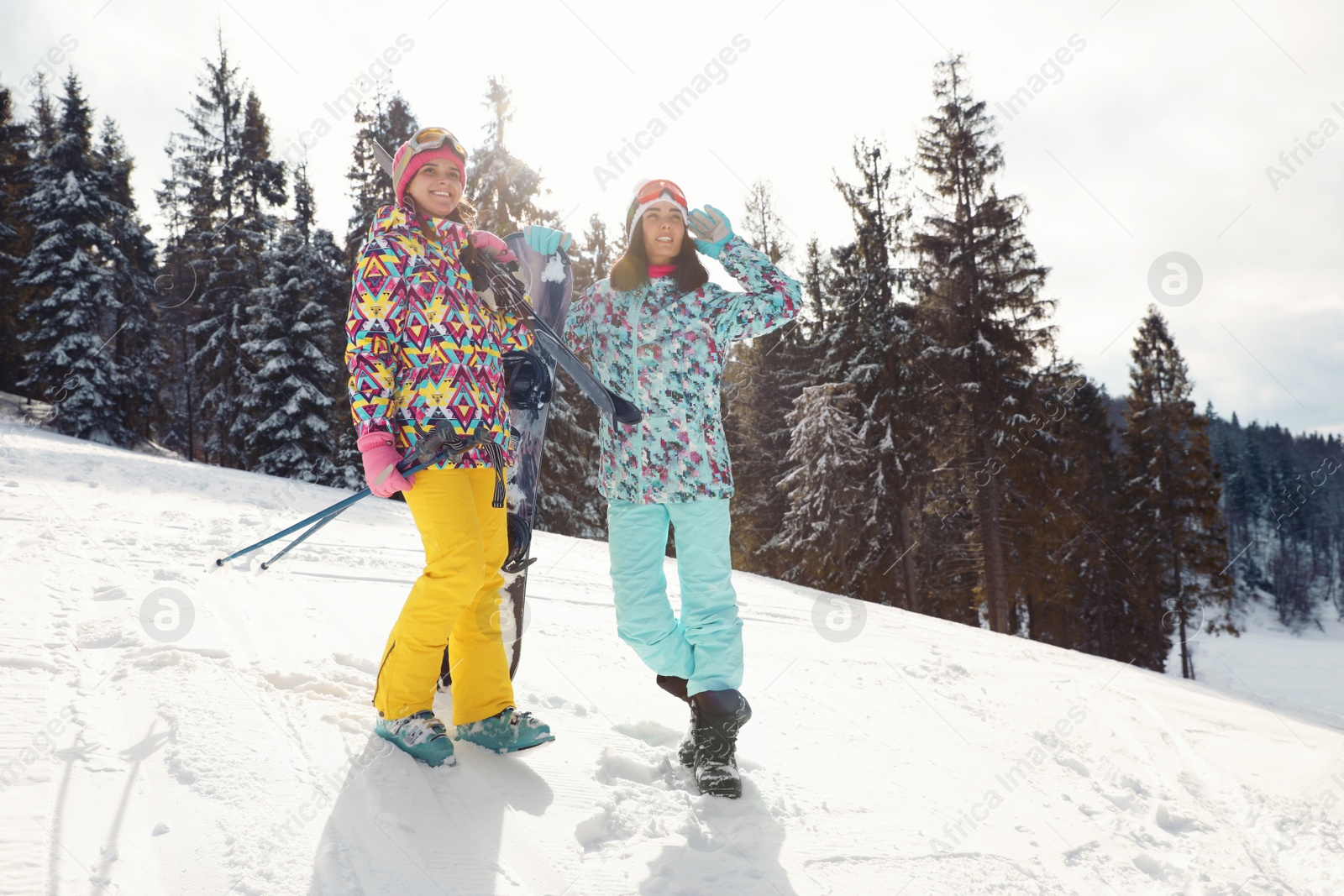 Photo of Friends with equipment on snowy hill. Winter vacation