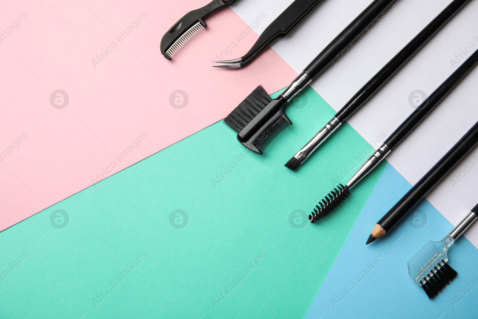 Photo of Set of professional eyebrow tools on color background, flat lay. Space for text