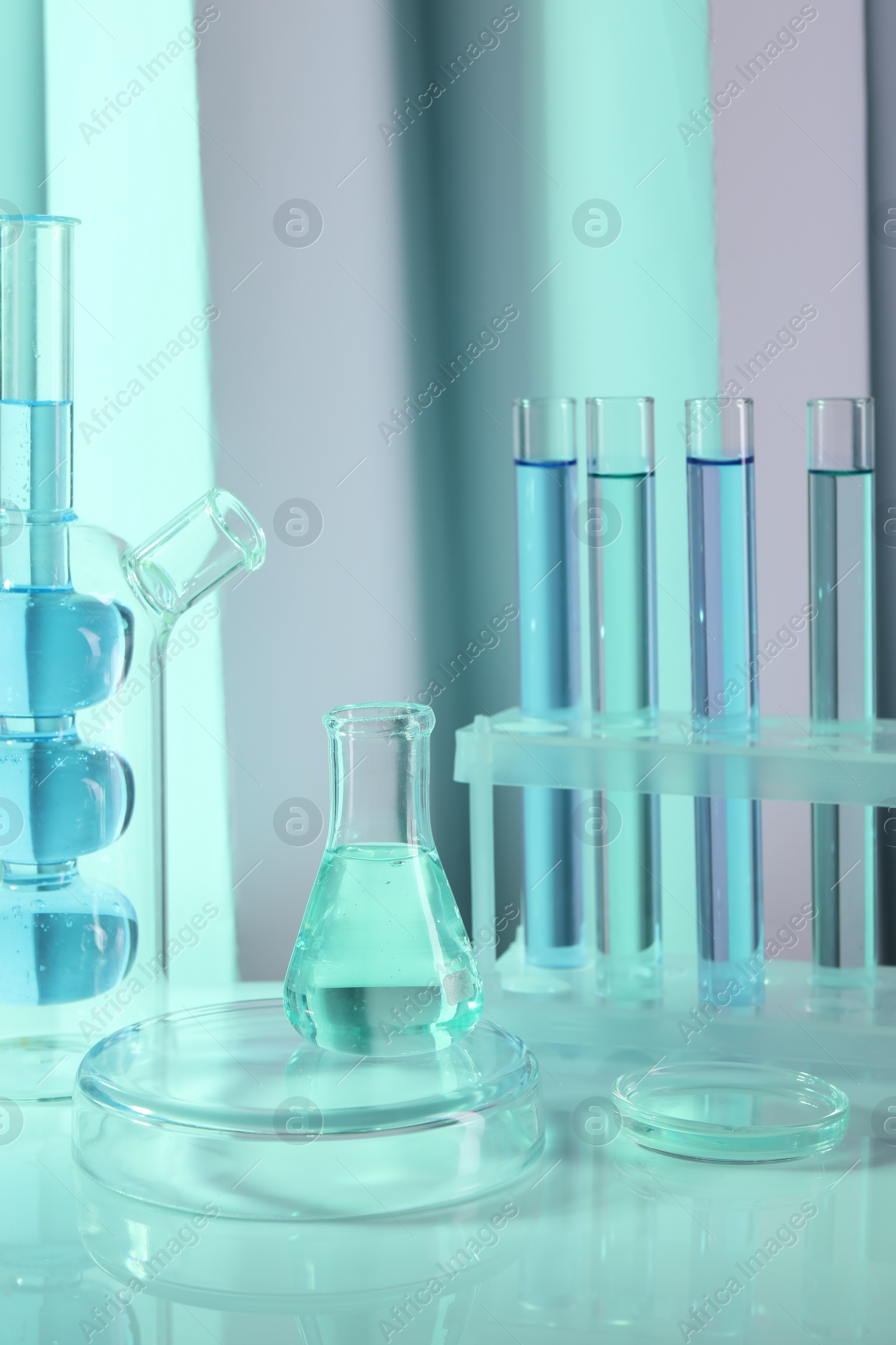 Photo of Laboratory analysis. Different glassware on table against color background