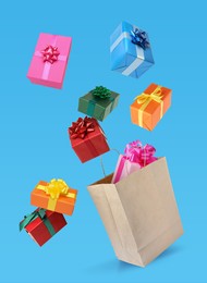 Image of Many different gift boxes falling into paper shopping bag on light blue background