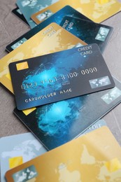 Photo of Credit cards on grey textured table, closeup