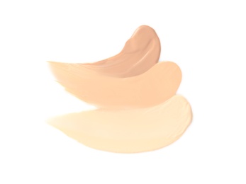 Photo of Samples of different foundation shades on white background, top view