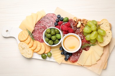 Photo of Snack set with delicious Parmesan cheese on light wooden table, top view