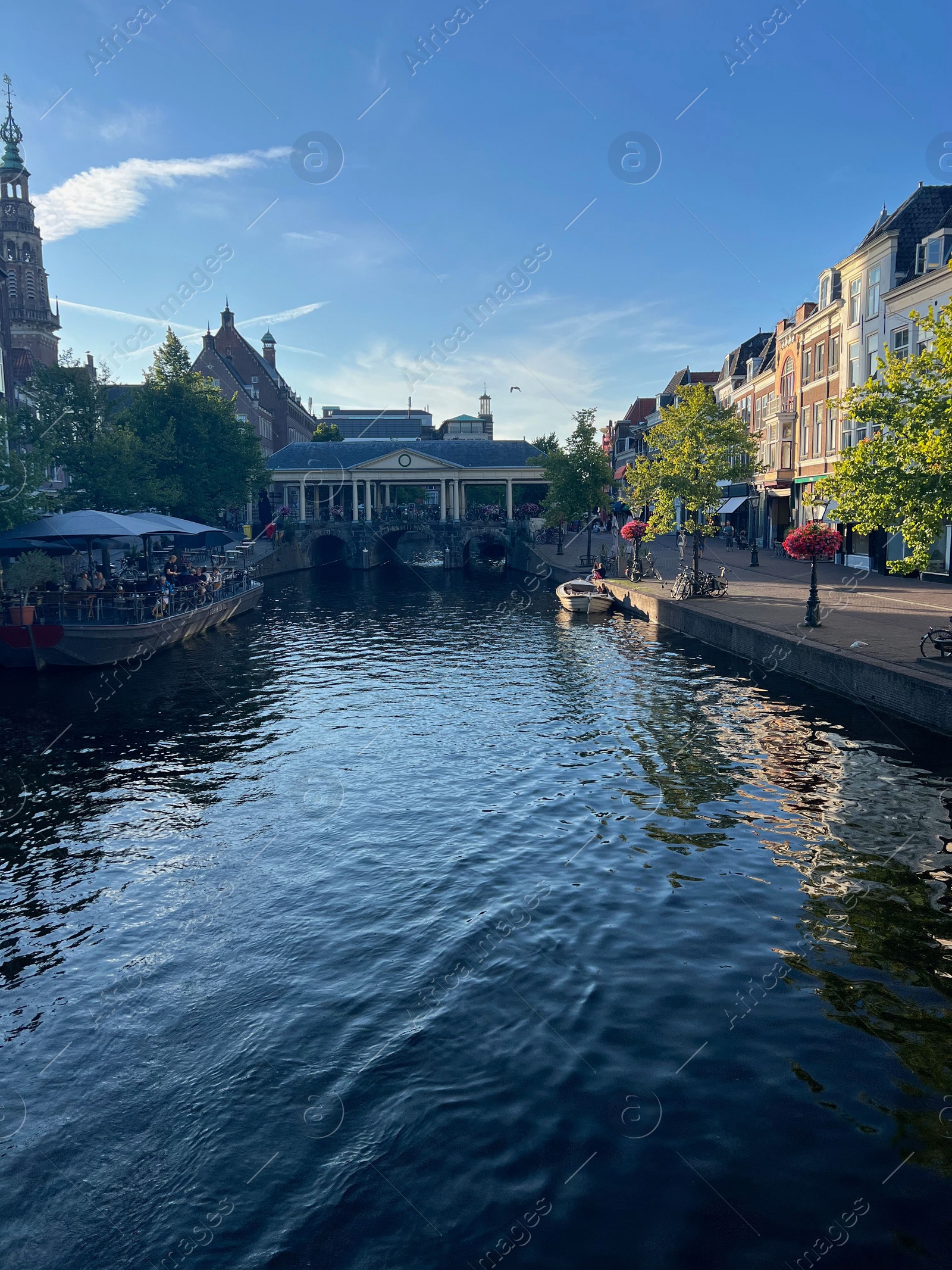 Photo of Leiden, Netherlands - August 1, 2022: Picturesque view of city canal and beautiful buildings