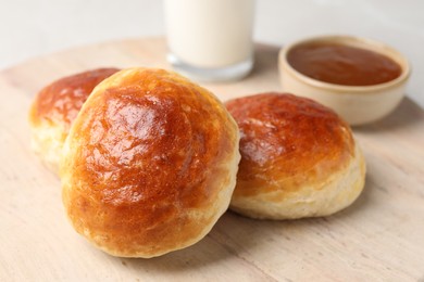 Photo of Freshly baked soda water scones on wooden table, closeup