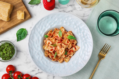Photo of Flat lay composition with tasty pasta on white marble table