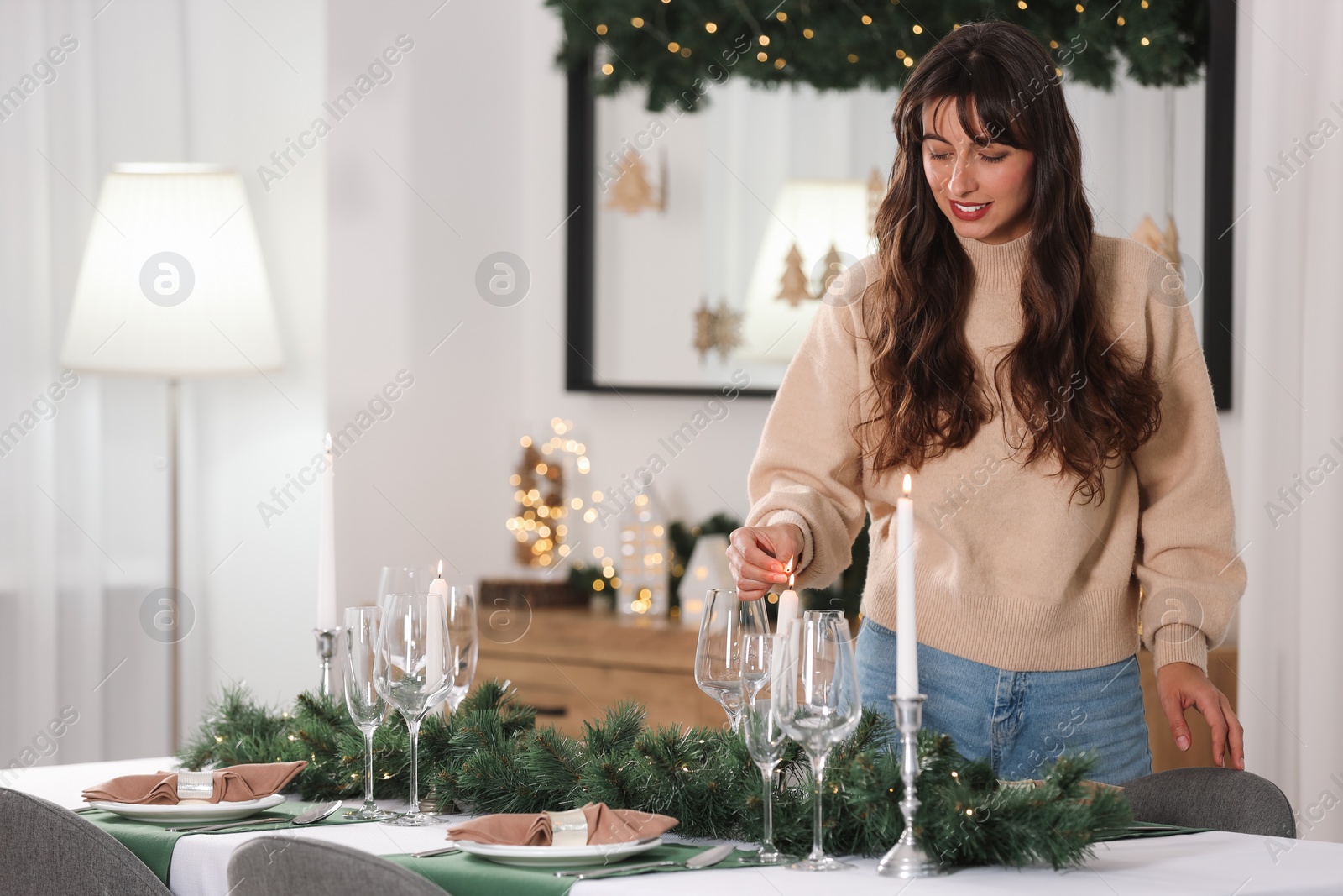 Photo of Smiling woman setting table for Christmas celebration at home. Space for text