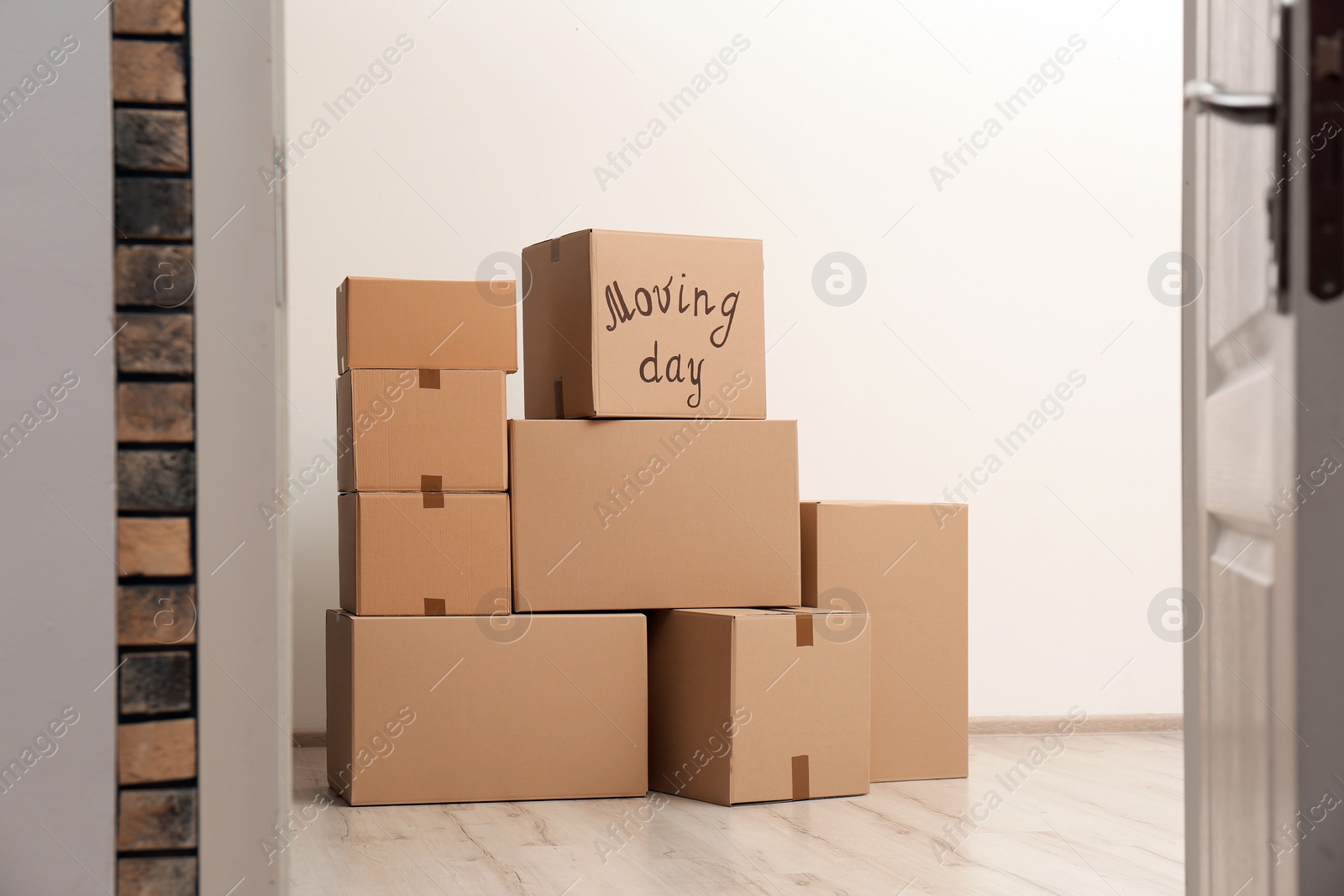 Photo of Pile of moving boxes in empty room