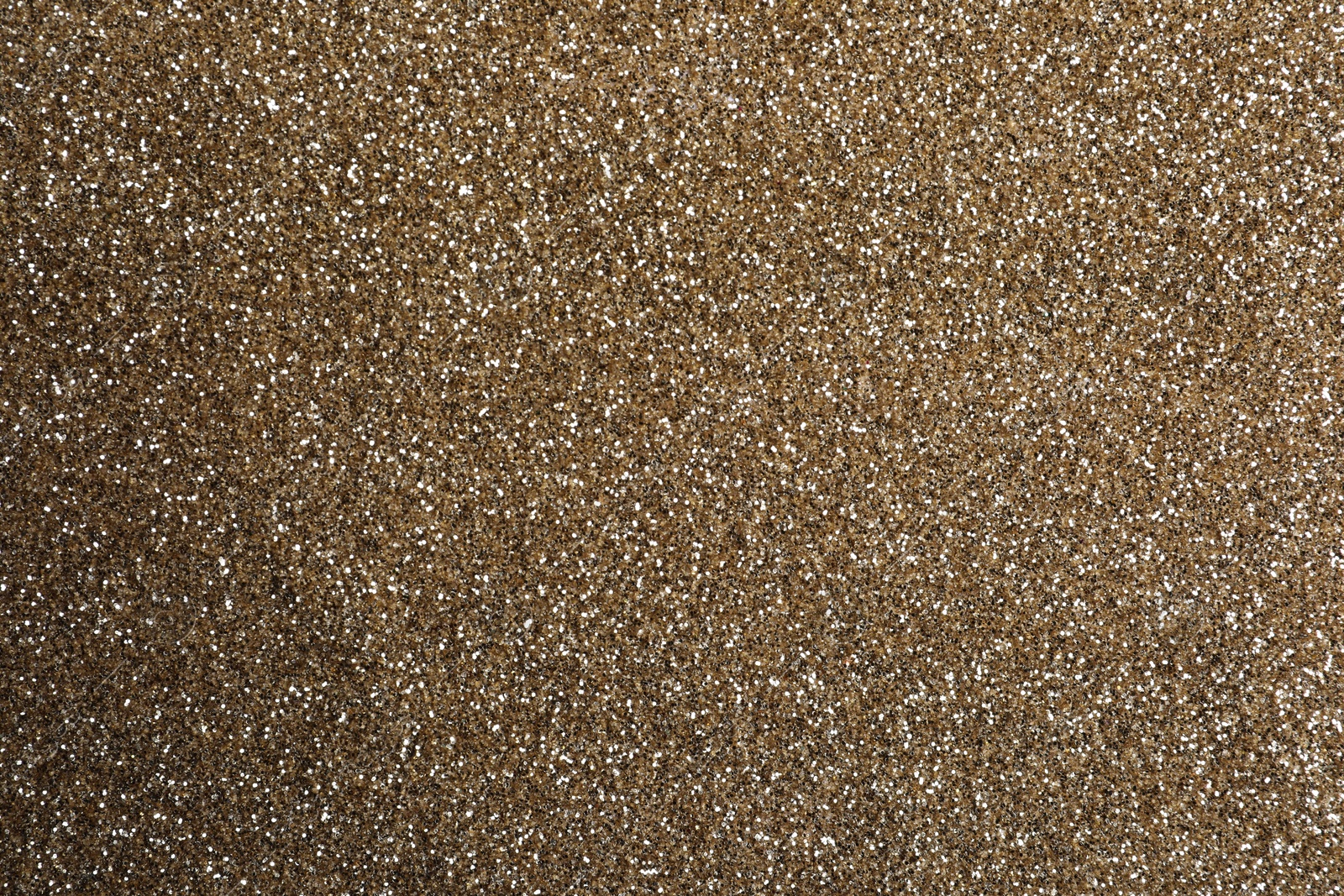 Photo of Shiny light brown glitter as background, closeup