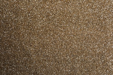 Shiny light brown glitter as background, closeup