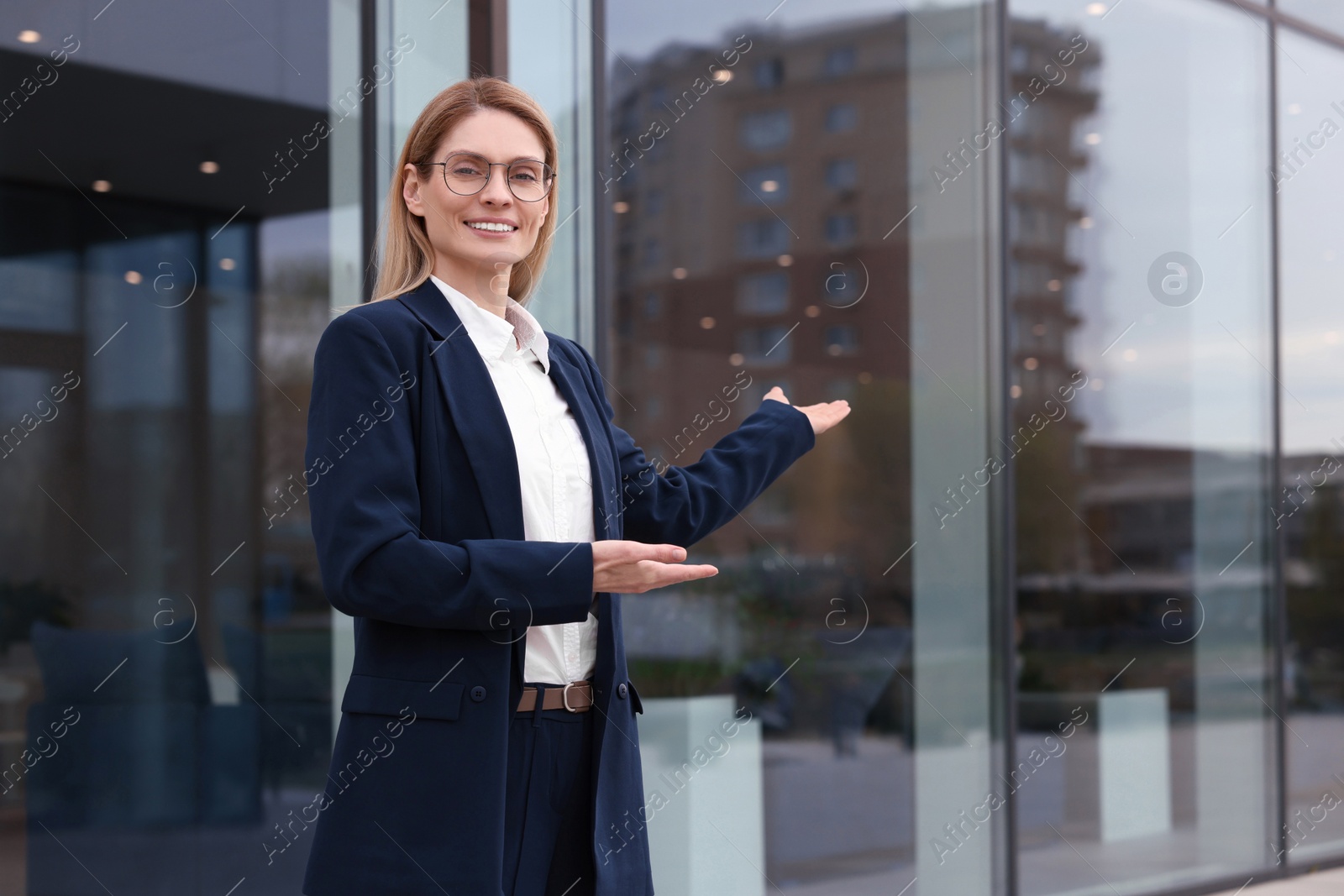 Photo of Happy real estate agent outdoors. Space for text