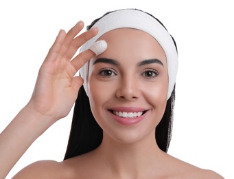 Woman using silkworm cocoon in skin care routine on white background