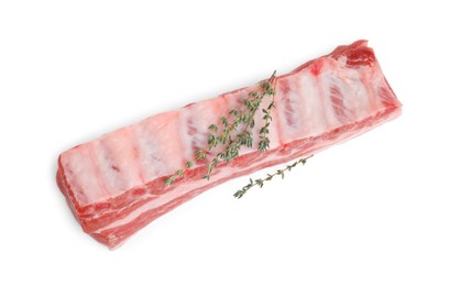Photo of Raw pork ribs with thyme isolated on white, top view