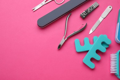 Photo of Set of pedicure tools on pink background, flat lay. Space for text