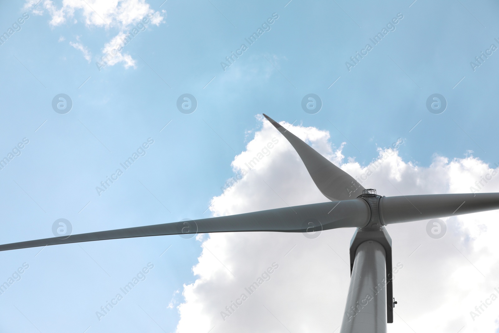 Photo of Modern wind turbine against blue sky, low angle view. Energy efficiency