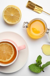 Photo of Composition with lemon tea, honey and ginger on white background, top view