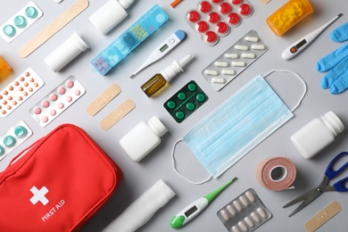 Photo of Flat lay composition with first aid kit on gray background