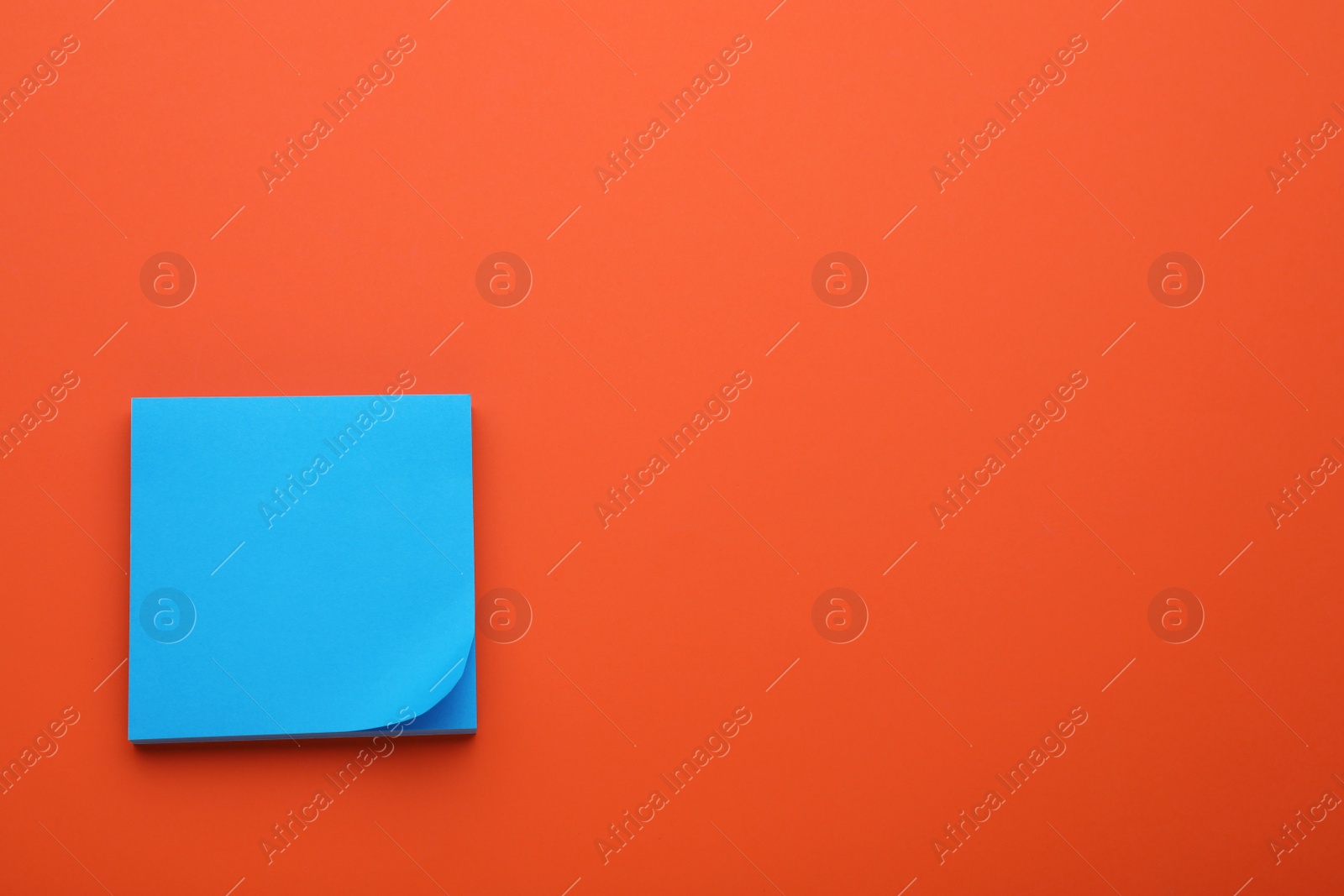 Photo of Paper note on orange background, top view. Space for text