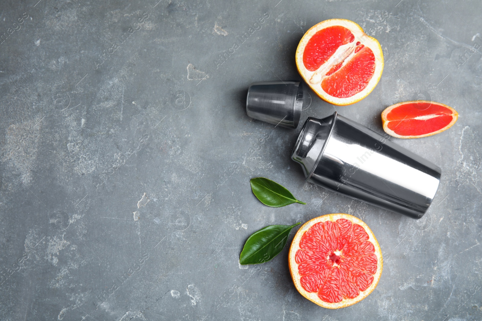 Photo of Flat lay composition with grapefruits and space for text on grey background