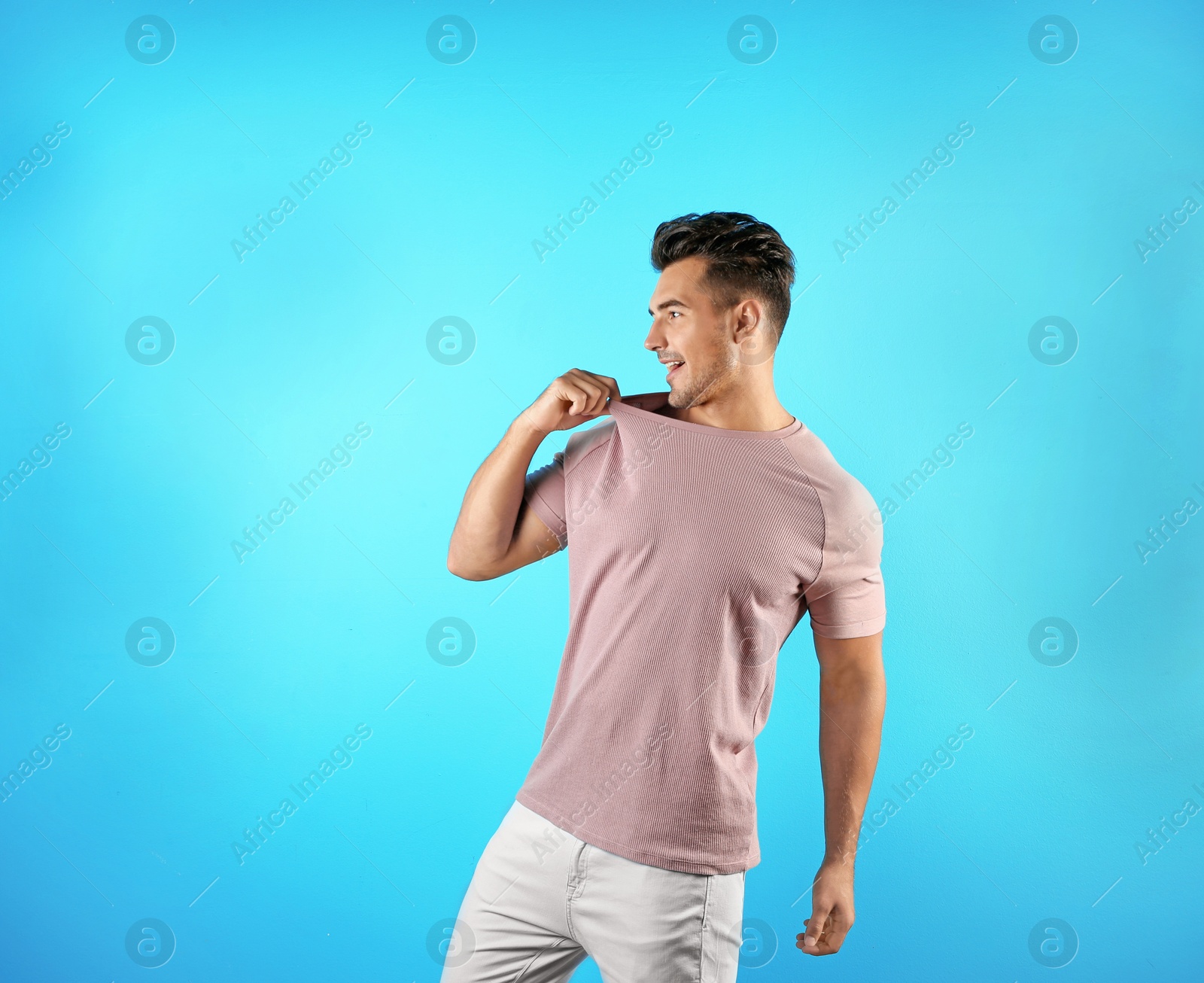 Photo of Young man in t-shirt on color background. Mockup for design