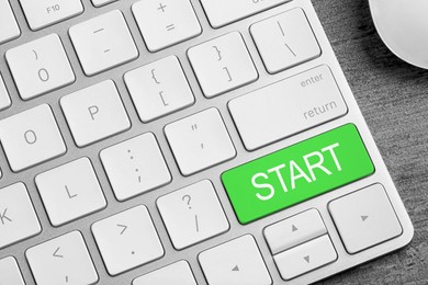 Green button with word Start on computer keyboard, closeup