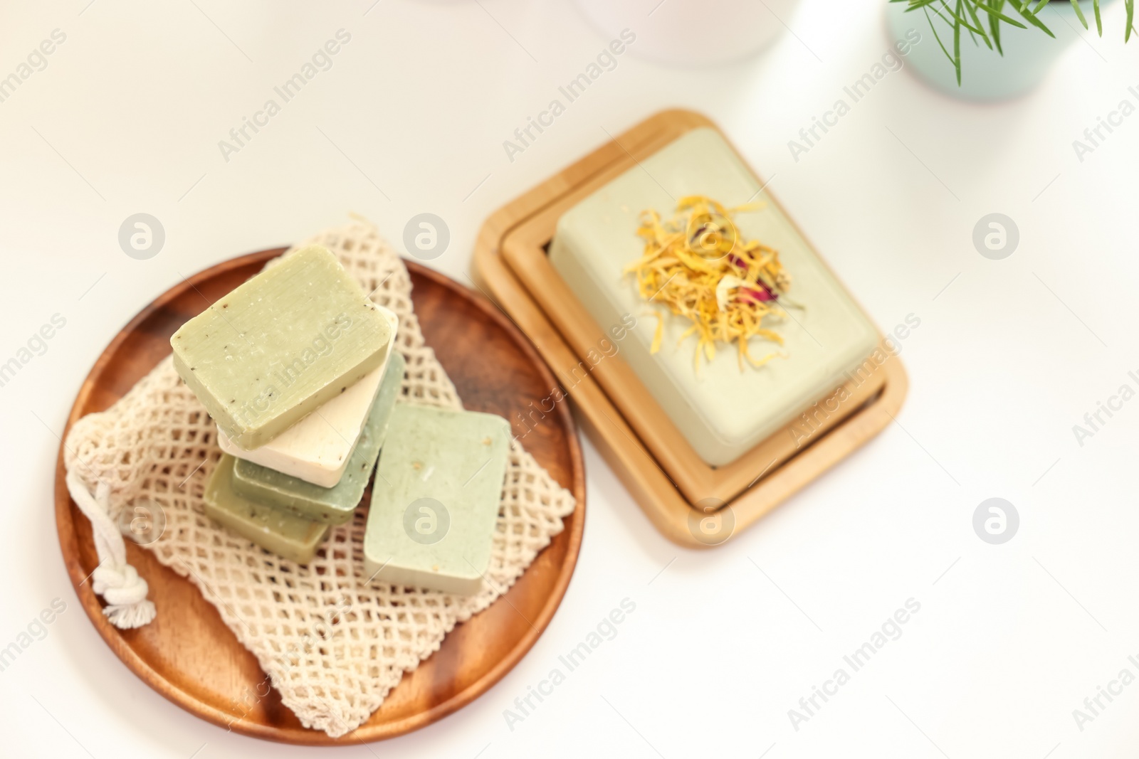 Photo of Soap bars on white table, above view. Spa time