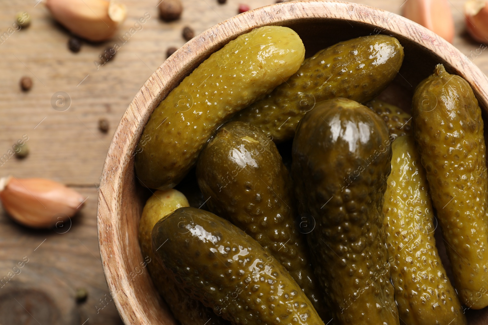 Photo of Tasty pickled cucumbers in bowl on table, top view