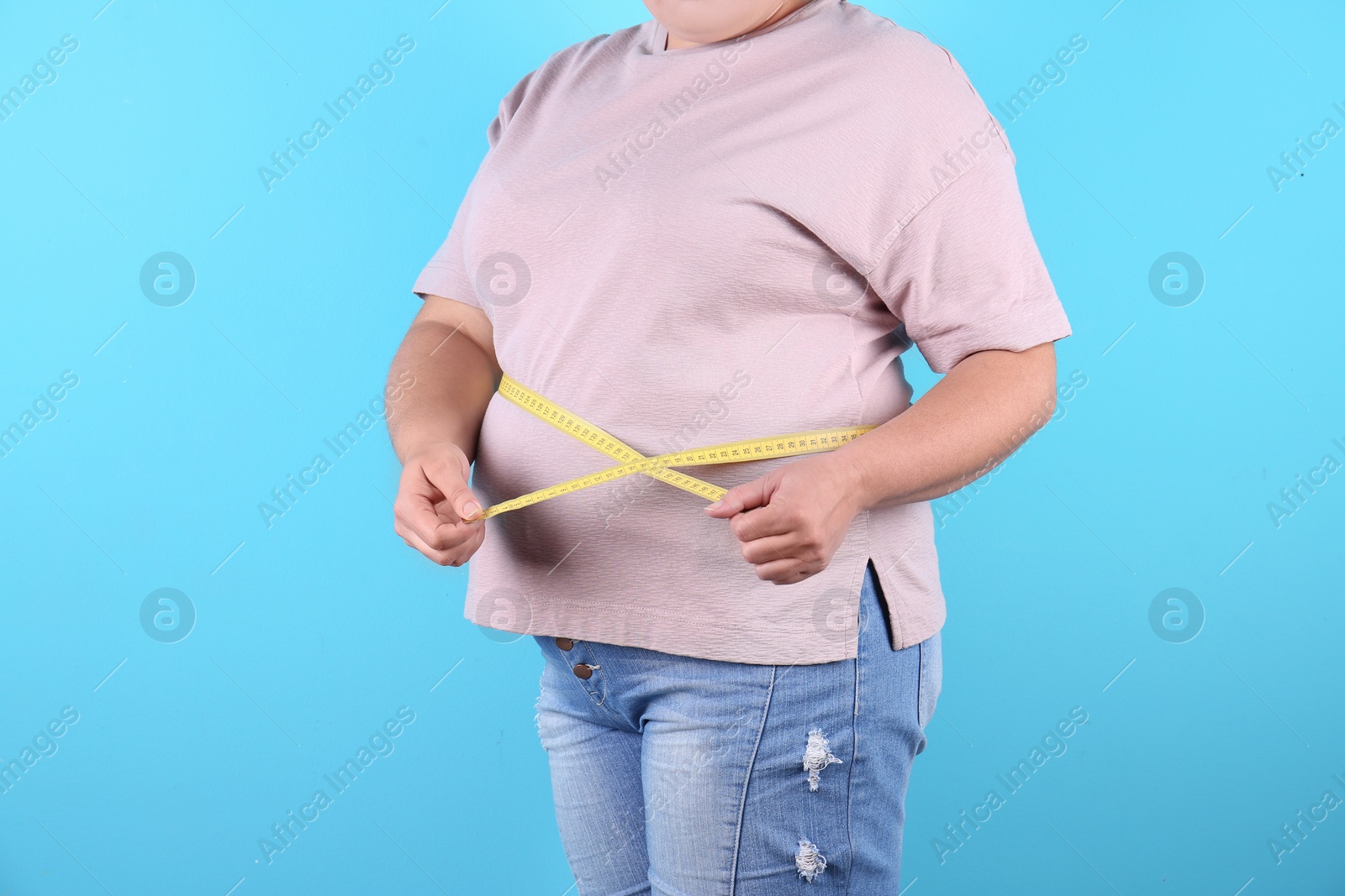 Photo of Fat woman with measuring tape on color background, closeup. Weight loss