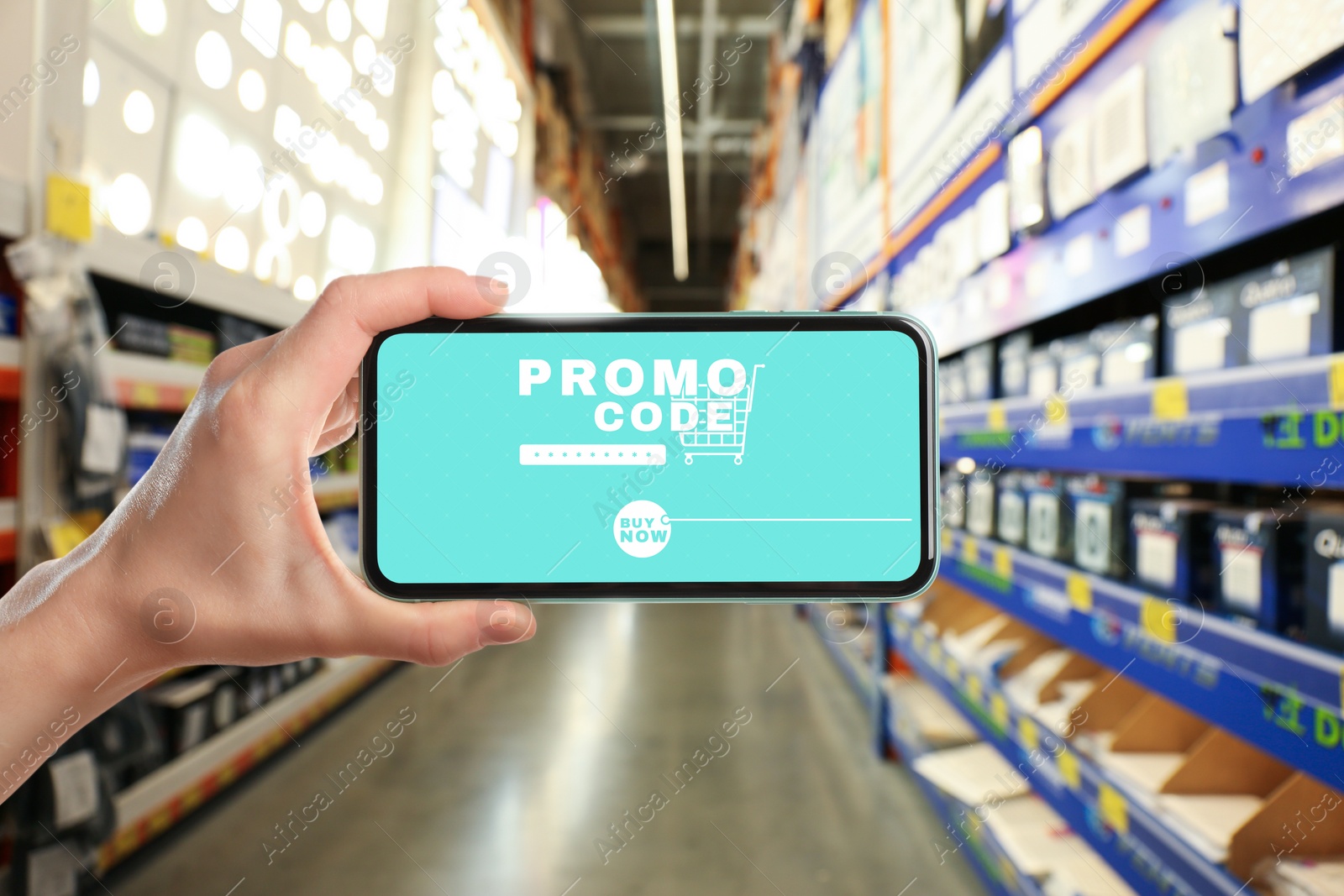 Image of Woman holding smartphone with activated promo code in shopping mall, closeup