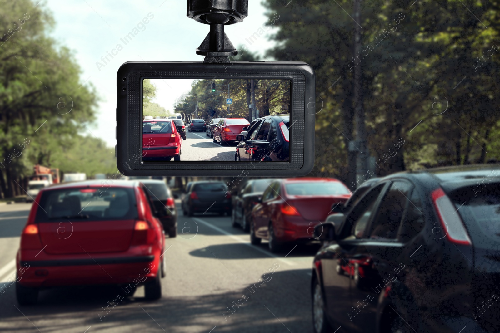 Image of Modern dashboard camera mounted in car, view of road during driving