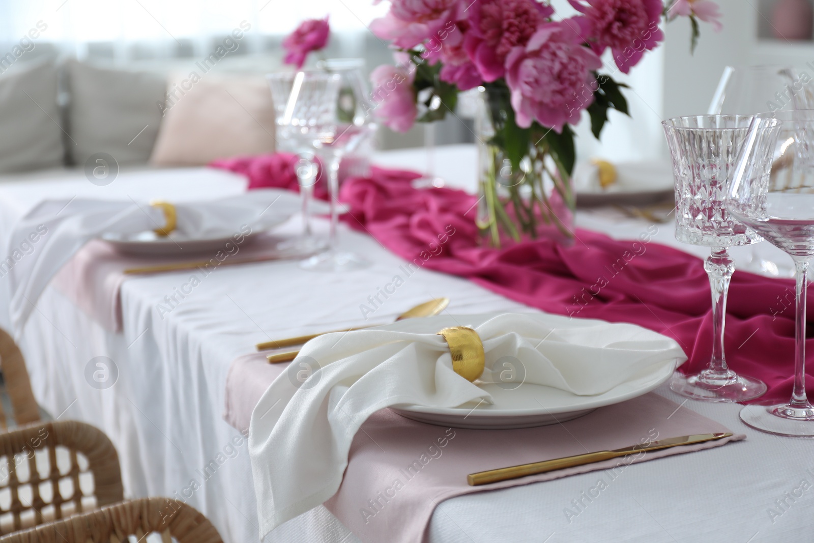 Photo of Beautiful table setting with pink peonies in dining room