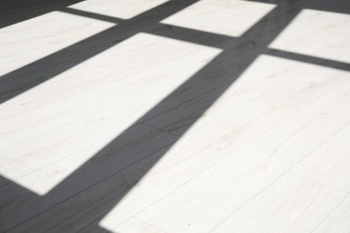 Photo of Shadow from window on white laminated floor indoors