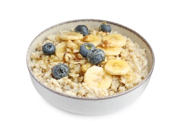 Photo of Tasty oatmeal with banana, blueberries, milk and walnuts in bowl isolated on white