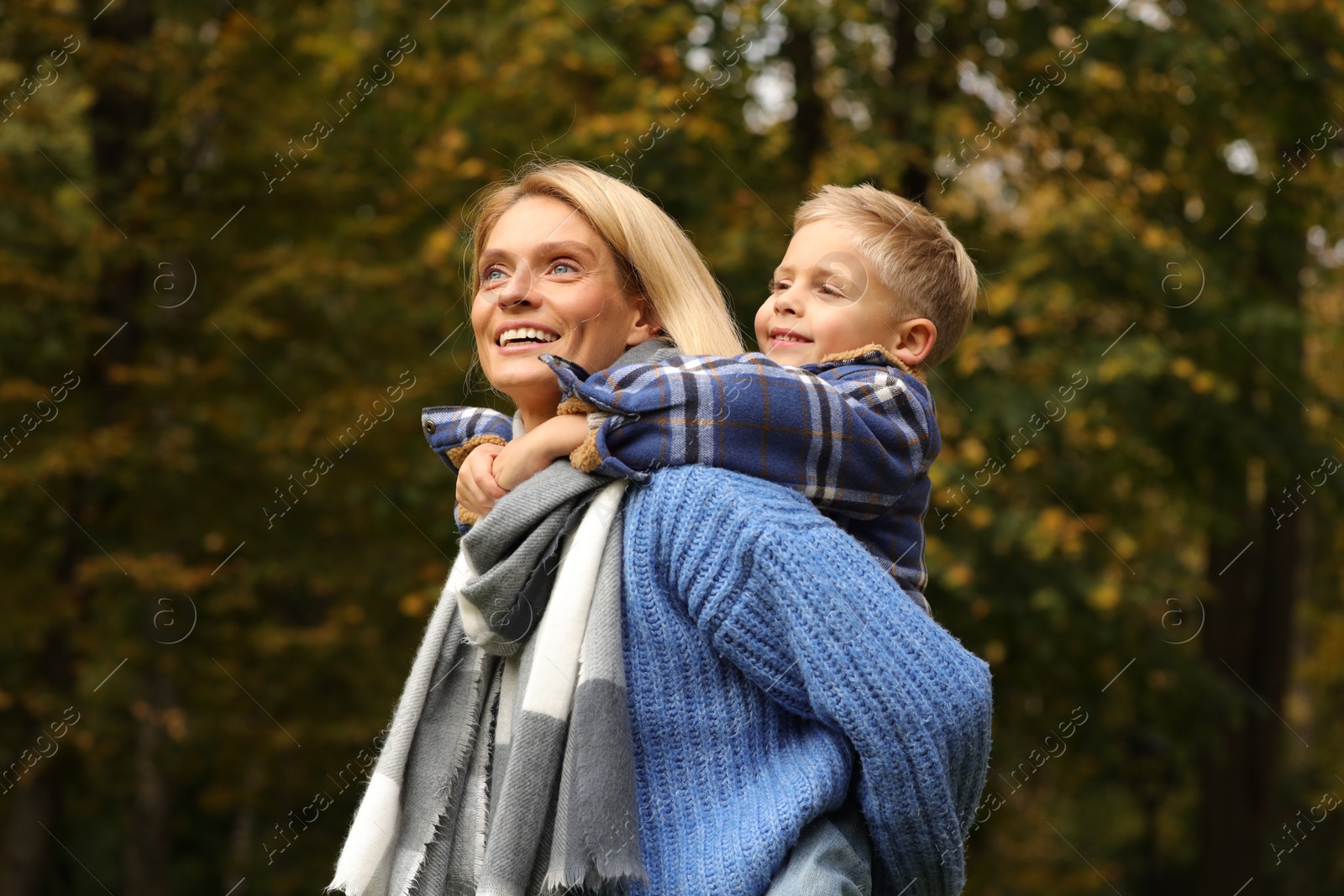Photo of Happy mother with her son in autumn park