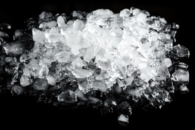 Photo of Heap of crushed ice on black table