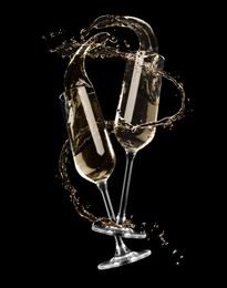 Glasses with sparkling wine and splashes on black background